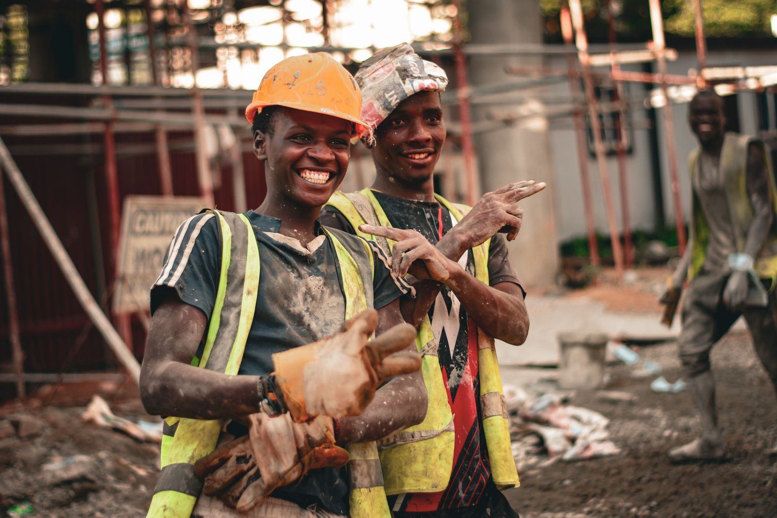 Smiling construction workers in safety vests on a site