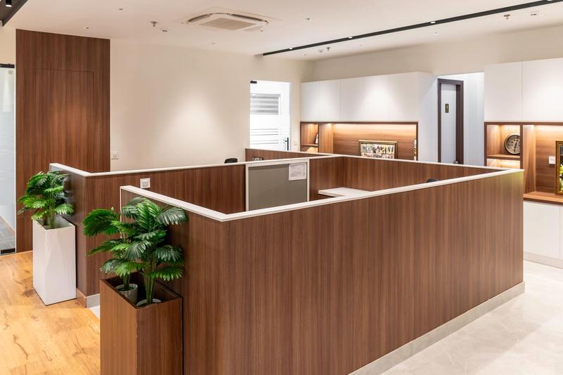 Modern office interior with wooden workstations and plants