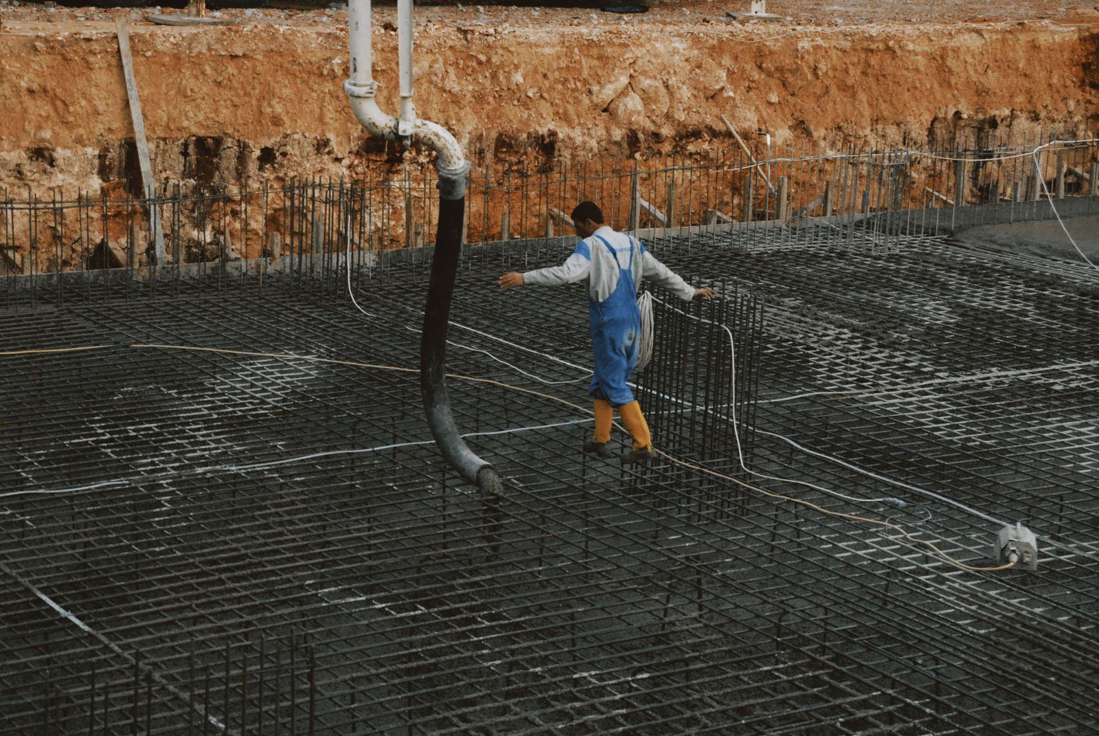 Workers pouring concrete for a reinforced slab