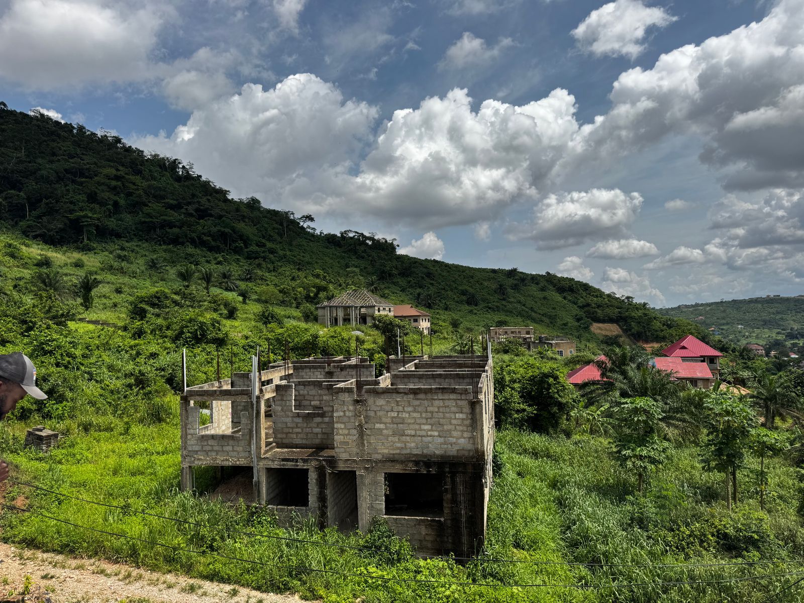 House under construction on a green hillside