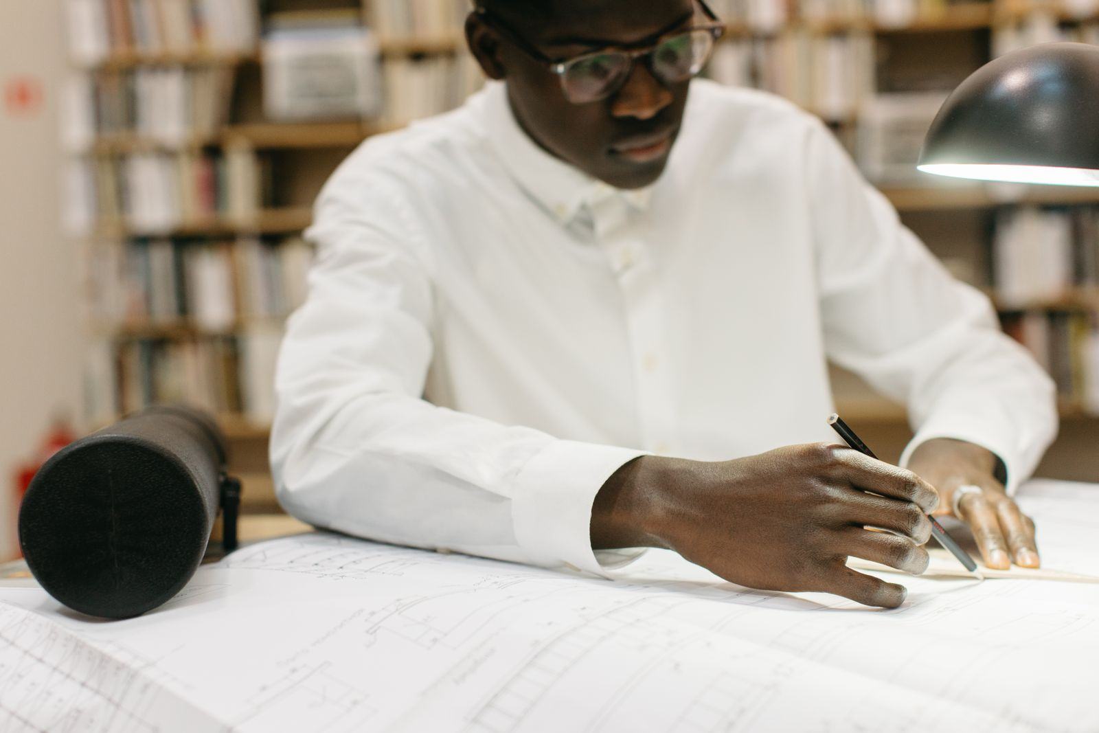 Architect working on drawings at a desk