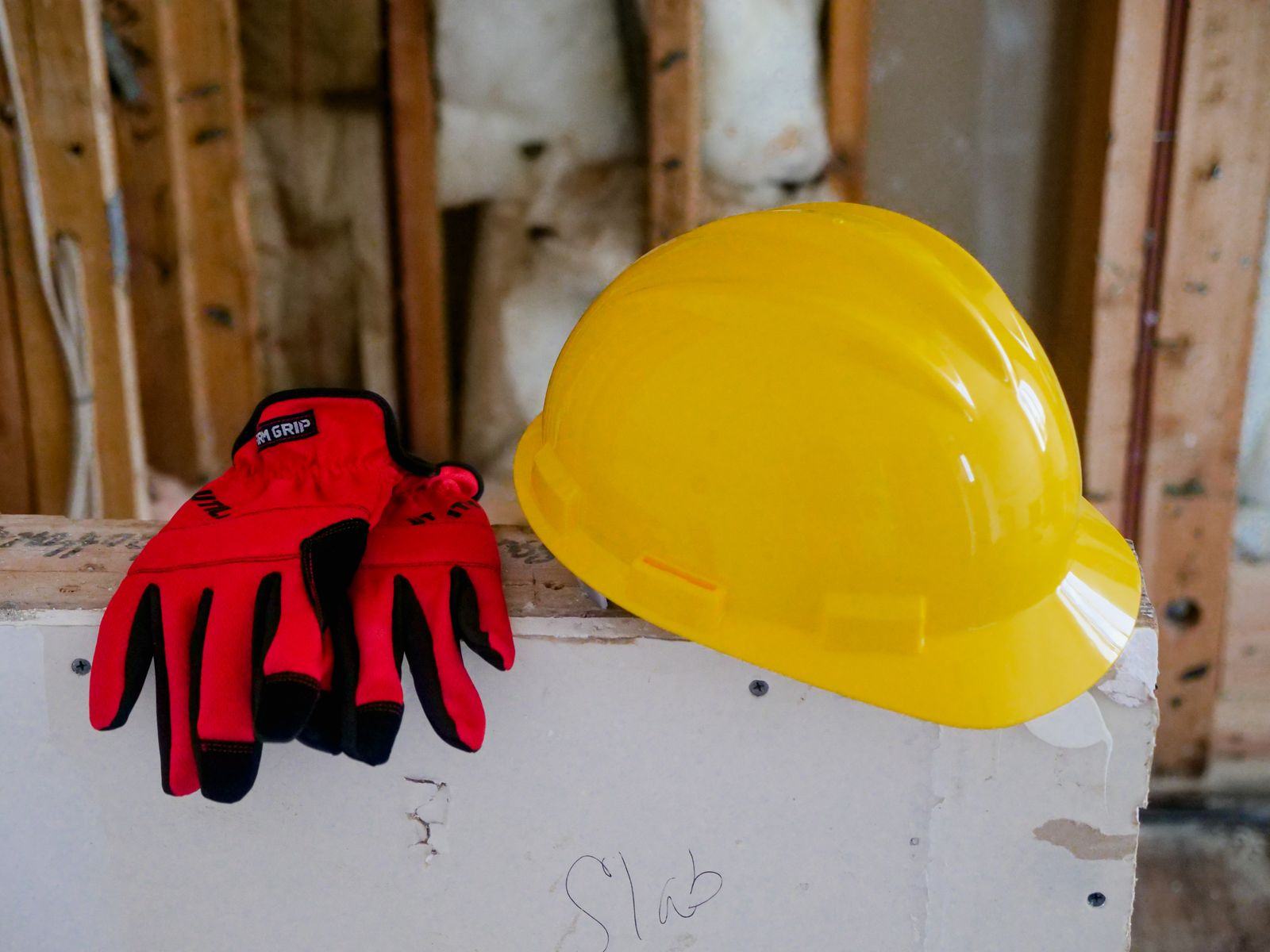 Hard hat and work gloves on a construction site