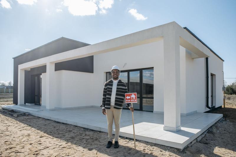 Homeowner standing in front of a newly built modern house