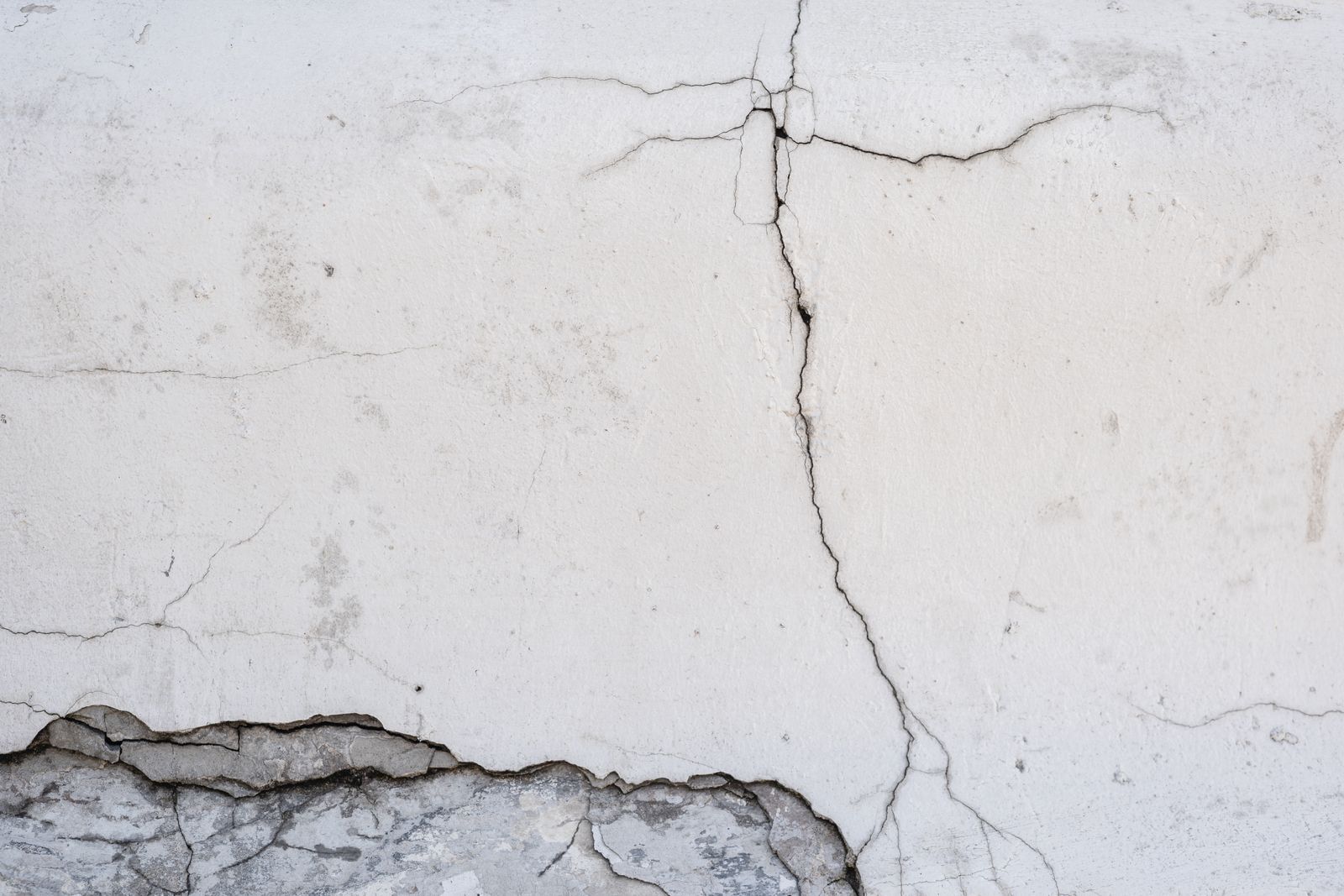Close-up of a cracked concrete wall showing surface texture details