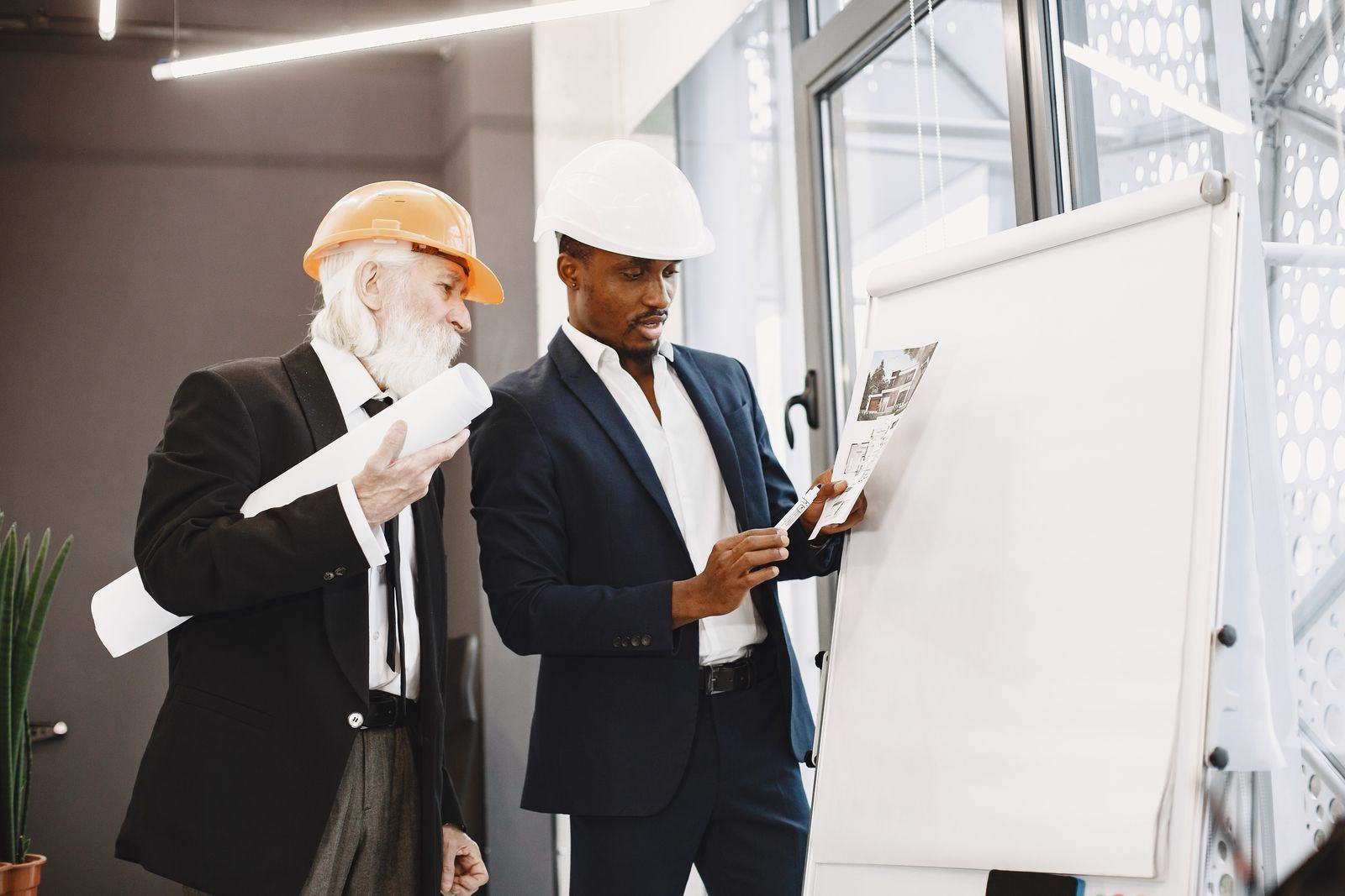 Engineers presenting building plans in a meeting