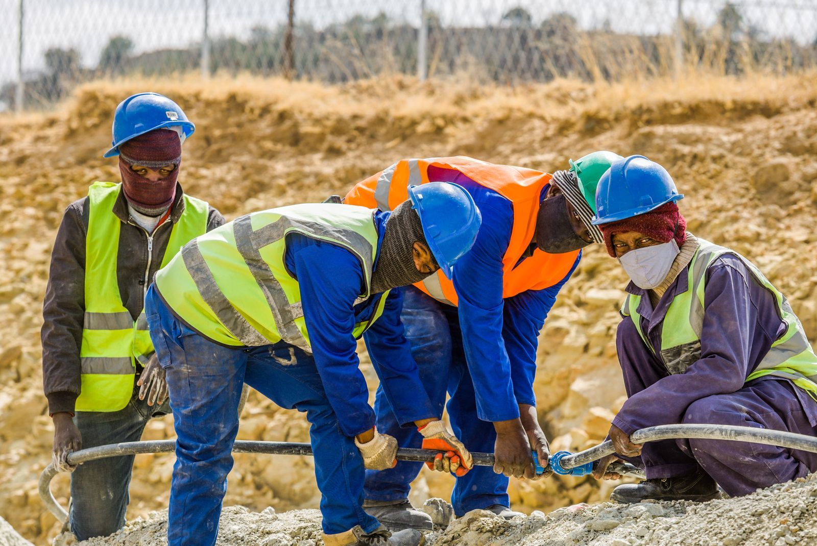 Team of construction workers in safety gear collaborating on a project outdoors in South Africa