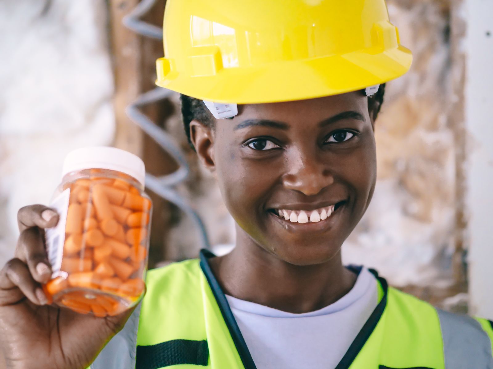 Smiling construction worker in safety gear on site