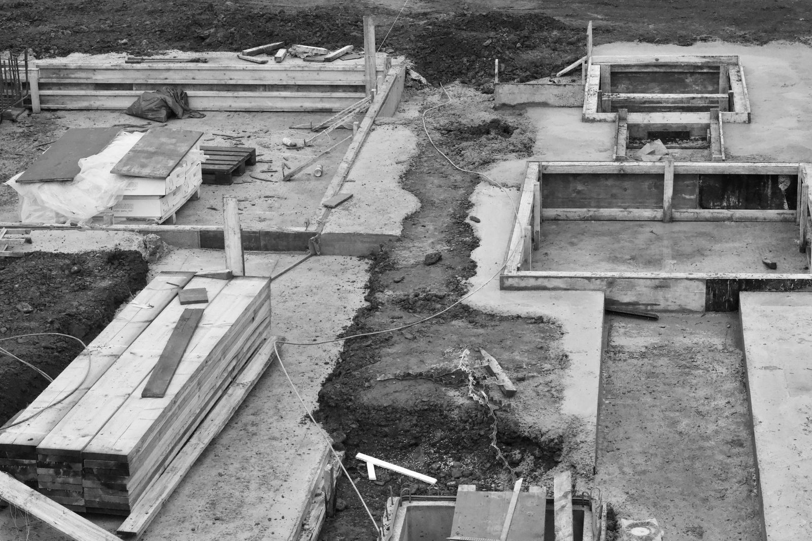 Aerial view of concrete foundations at a construction site, showing early building phases