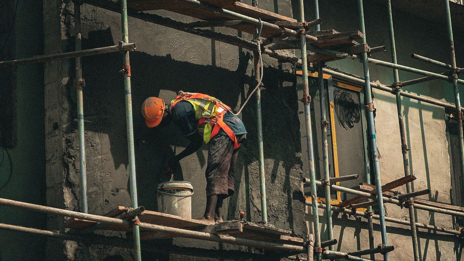 Construction worker on scaffolding at a building site