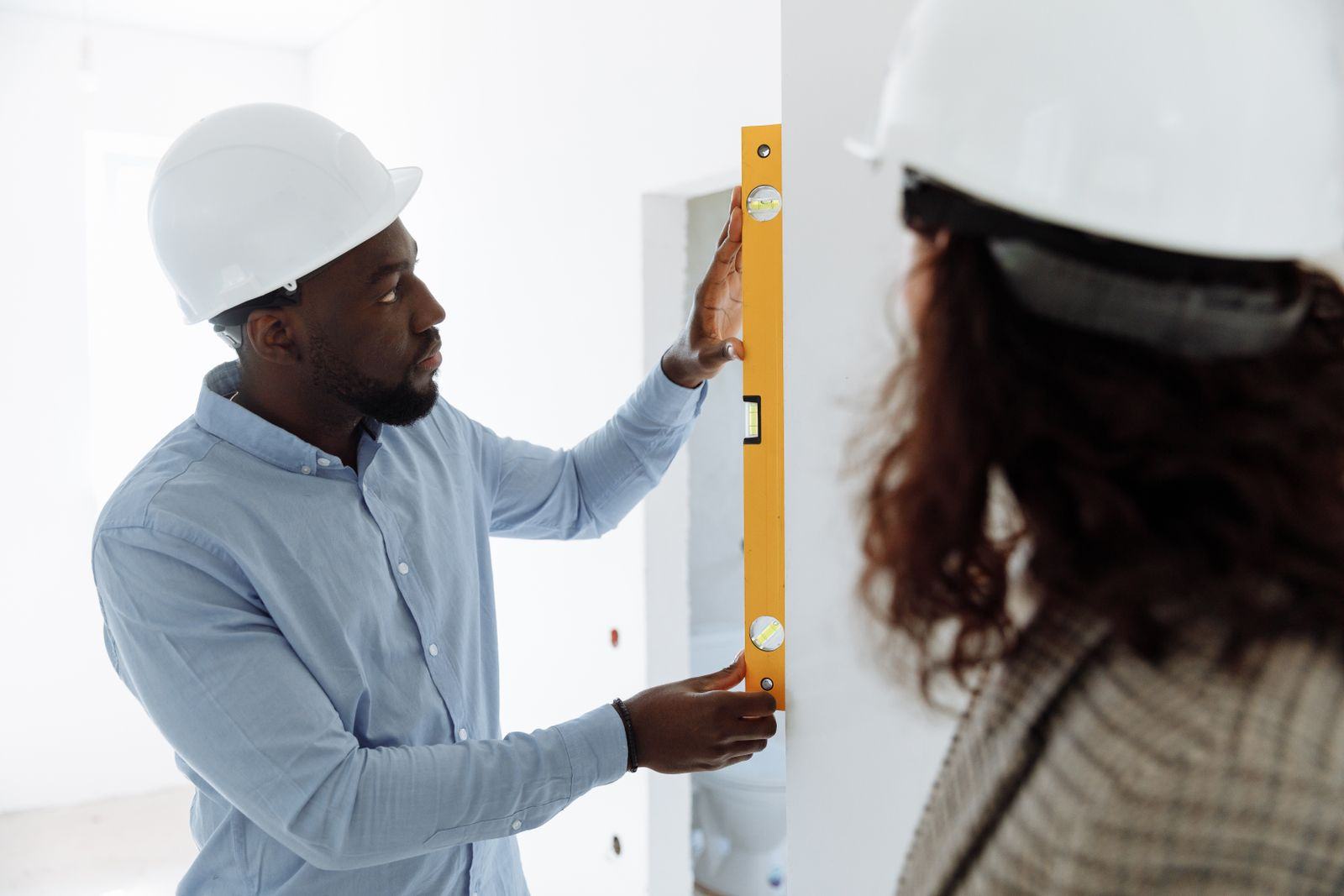 Engineer checking a wall with a spirit level