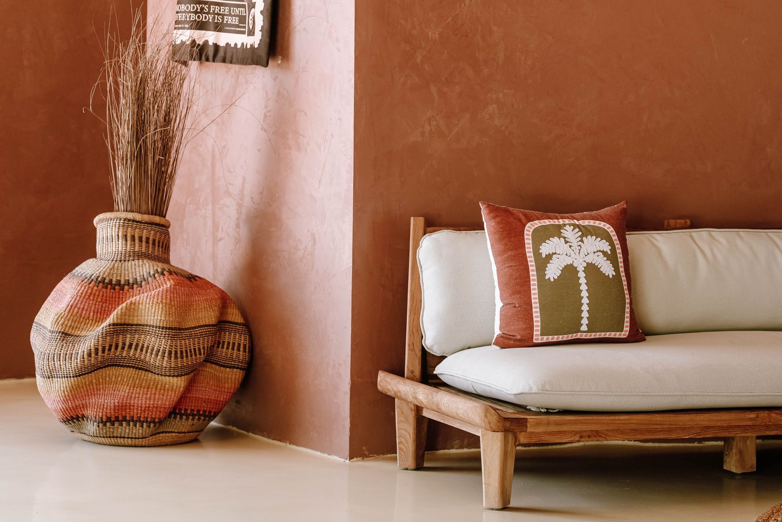 Bohemian living room with a wicker vase and palm-themed cushion in Jambiani, Tanzania