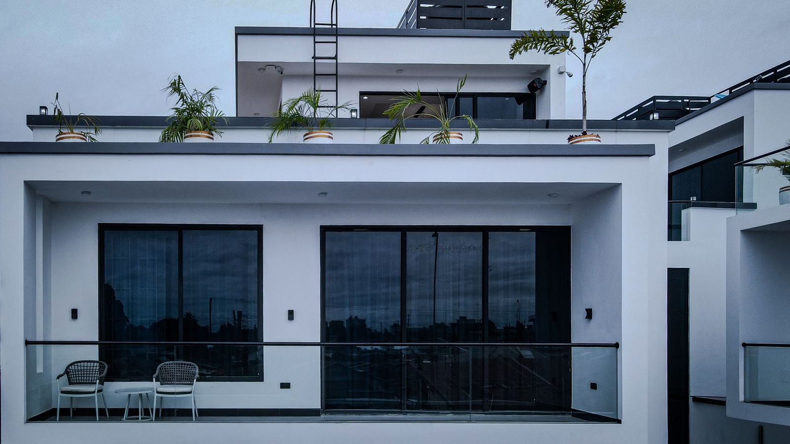 White building with balconies and potted plants in Dar es Salaam, Tanzania