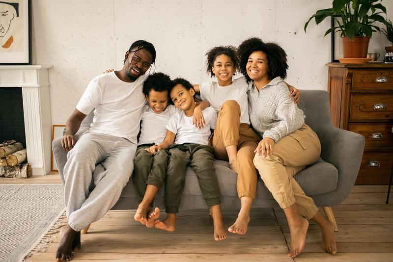 Happy family sitting together on a sofa at home