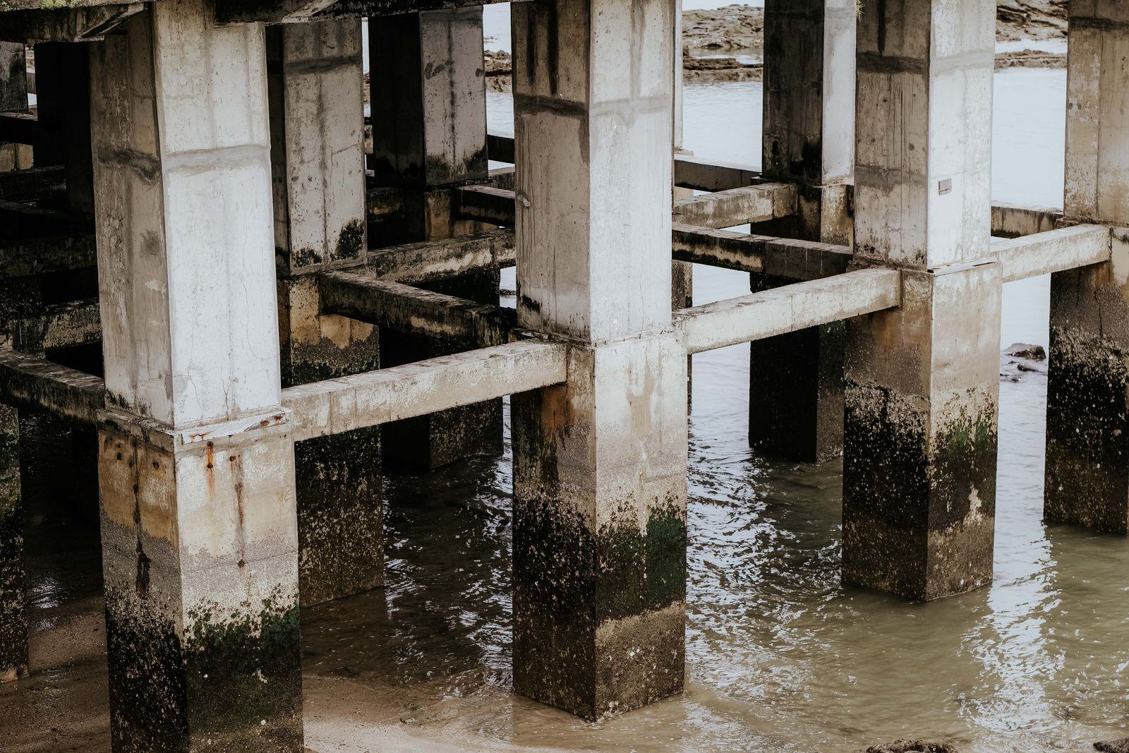 Flooded ground around building columns after heavy rain
