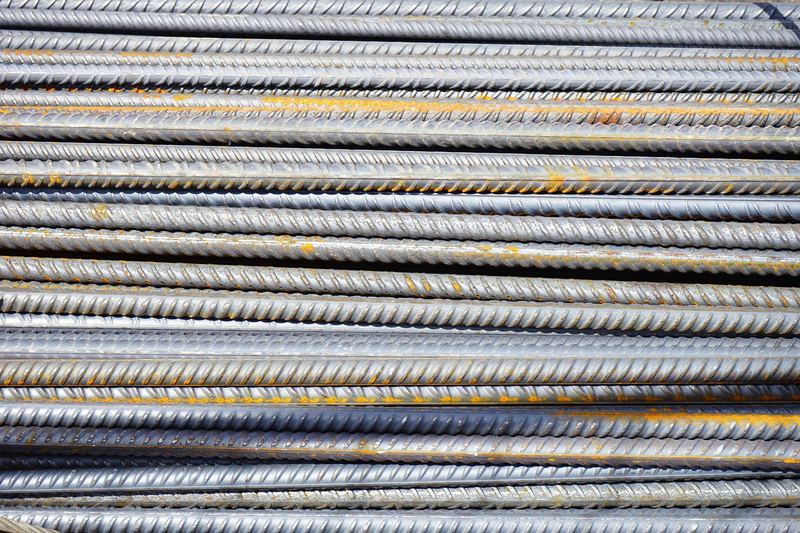 Close-up of stacked rusty steel reinforcing bars used in construction