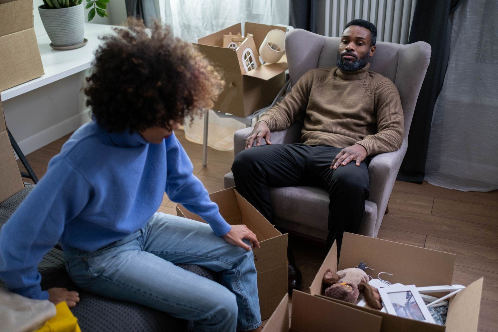 Couple surrounded by moving boxes in a new home