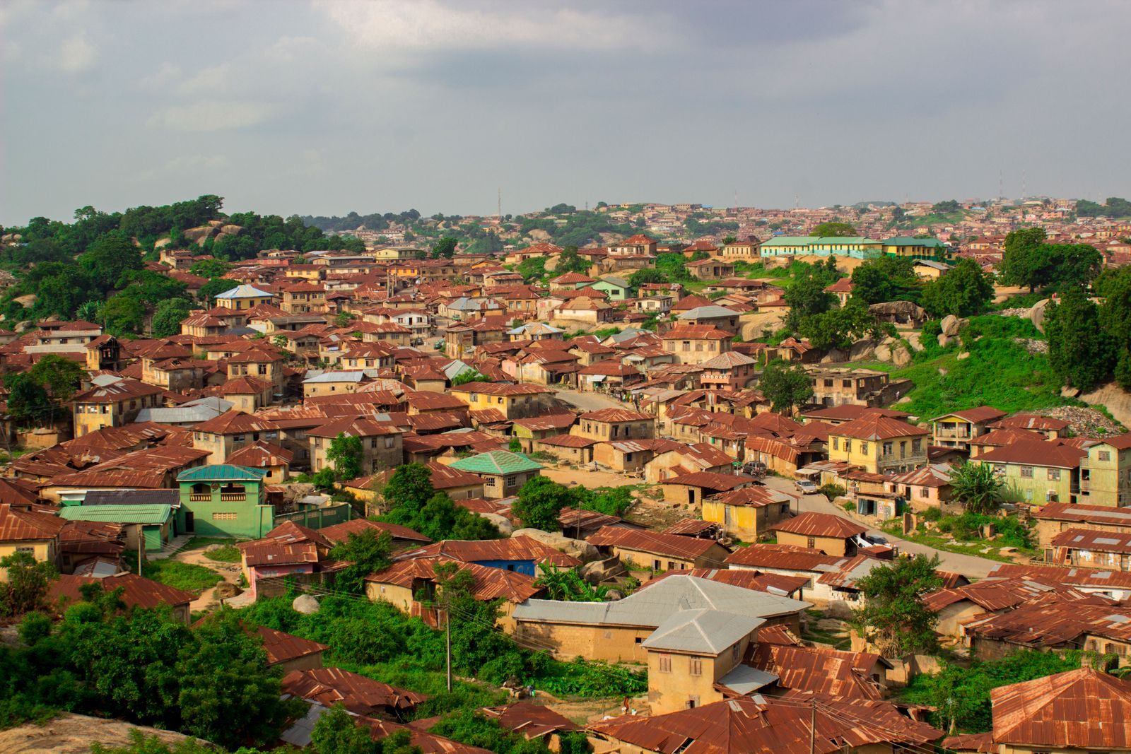 Aerial view of rustic rooftops in Abeokuta, Nigeria with greenery