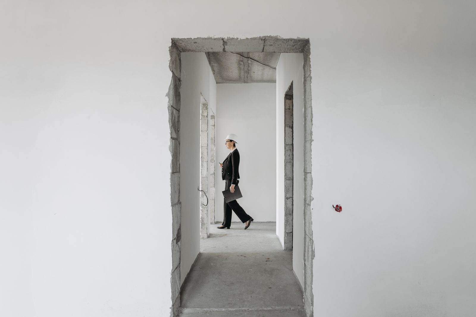 Woman inspecting an unfinished building before handover