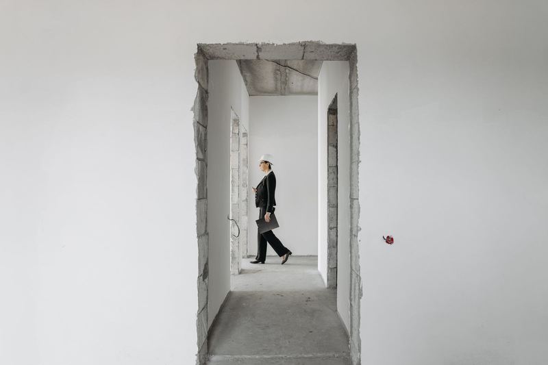 Woman inspecting an unfinished building before handover