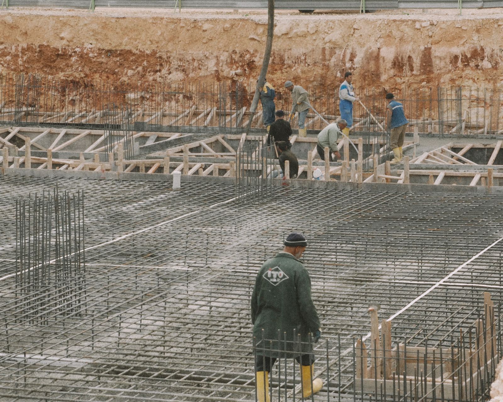 Workers building a foundation with rebar at a construction site